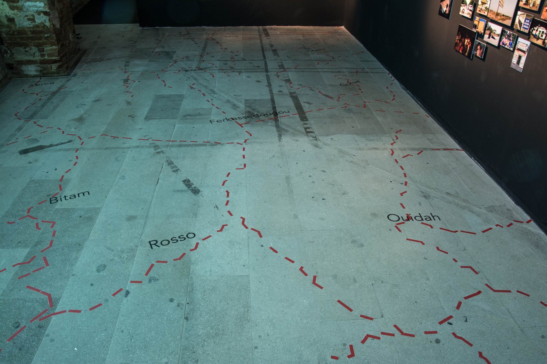 A cartographic floor marked with dashed routes and place names